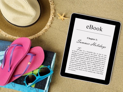 eBook reader, beach accessories on sand
